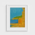 White-framed Cala Jondal landscape print by Colin Galloway, with golden cliffs, blue sea and a green headland.