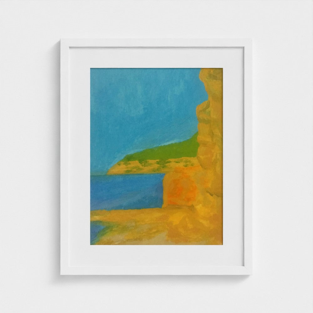 White-framed Cala Jondal landscape print by Colin Galloway, with golden cliffs, blue sea and a green headland.
