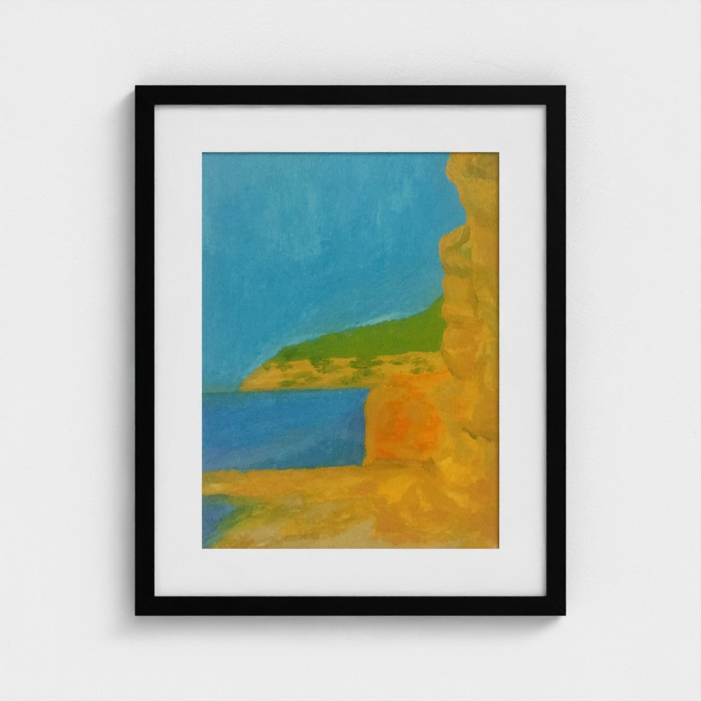 Black-framed Cala Jondal landscape print by Colin Galloway, with golden cliffs, blue sea and a green headland.
