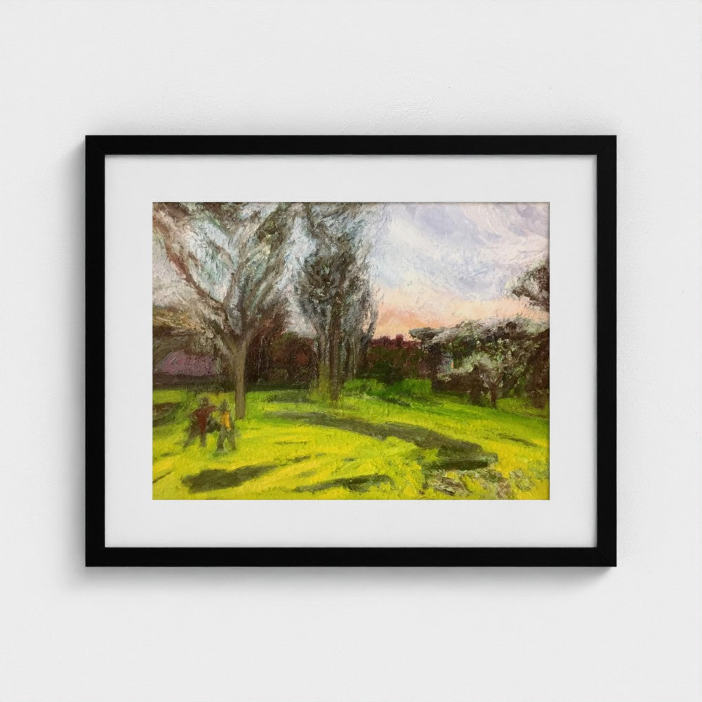 Black-framed Surrey spring evening print by Colin Galloway, with tall trees, green grass and long shadows.
